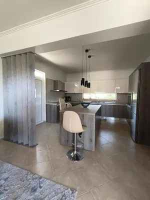 a kitchen with a table and a chair in it at Villa Agapi in Pastida