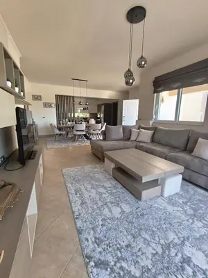 a living room with a couch and a table at Villa Agapi in Pastida
