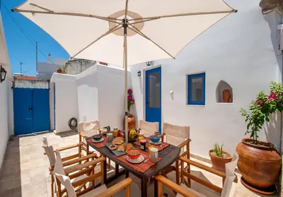 a dining room with a table and an umbrella at Villa Gennadi Essence in Gennadi