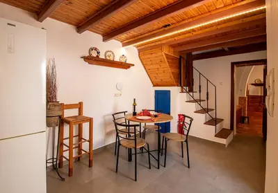 a kitchen with a table and chairs in a room at Villa Gennadi Essence in Gennadi