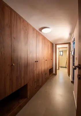 a hallway with wooden cabinets and a hallway with a door at Villa Gennadi Essence in Gennadi