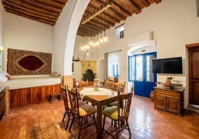 a living room with a table and chairs and a bed at Villa Gennadi Essence in Gennadi