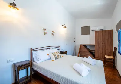 a bedroom with a bed with two towels on it at Villa Gennadi Essence in Gennadi