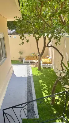 a view of a yard with a tree at Hidden Lemons - Boho stay in Rhodes in Rhodes Town