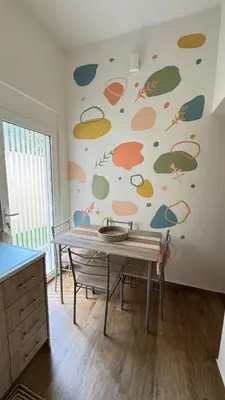 a room with a table and a wall with fish painted on it at Hidden Lemons - Boho stay in Rhodes in Rhodes Town