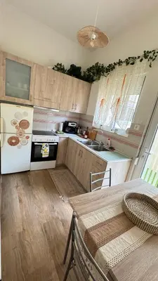a kitchen with a table and a stove top oven at Hidden Lemons - Boho stay in Rhodes in Rhodes Town