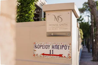 a sign on a wall that says no homesmith luxury suites at Monte Smith Luxury Suites in Rhodes Town