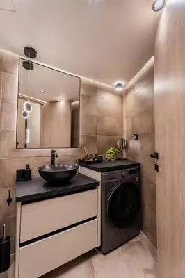 a bathroom with a sink and a washing machine at Monte Smith Luxury Suites in Rhodes Town