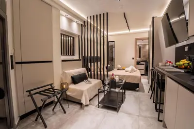 a kitchen and a living room with a couch and a table at Monte Smith Luxury Suites in Rhodes Town