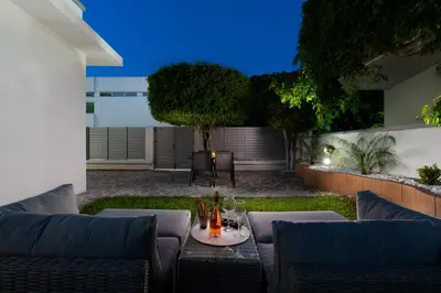 a patio with a couch and a table at Duo Verde Soil Garden Apartment in Kremasti