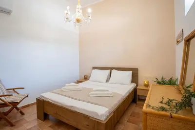 a bedroom with a bed with towels on it at 1944-Heritage House in Lardos