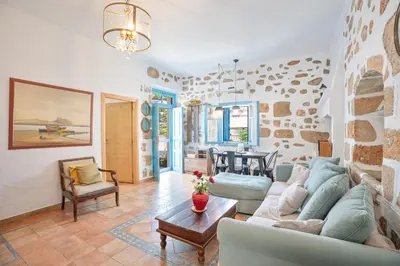 a living room with a couch and a table at 1944-Heritage House in Lardos