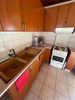 a kitchen with a sink and a stove at Aparment in a country house in Ialyssos
