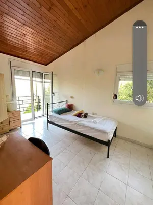 a bedroom with a bed in a room with windows at Aparment in a country house in Ialyssos