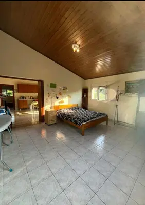 a large room with a bed in the middle of it at Aparment in a country house in Ialyssos