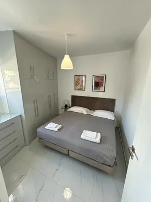a bedroom with a bed with two towels on it at Clementine Stay Rhodes - CAR RENTAL AVAILABLE in Rhodes Town