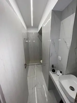a white bathroom with a shower and a sink at Clementine Stay Rhodes - CAR RENTAL AVAILABLE in Rhodes Town