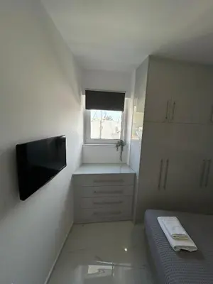 a small room with a bed and a television at Clementine Stay Rhodes - CAR RENTAL AVAILABLE in Rhodes Town