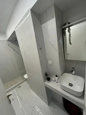 a white bathroom with a sink and a shower at Clementine Stay Rhodes - CAR RENTAL AVAILABLE in Rhodes Town
