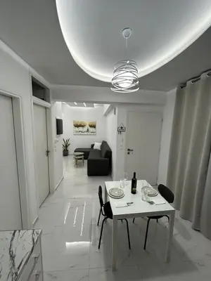 a living room with a table and a couch at Clementine Stay Rhodes - CAR RENTAL AVAILABLE in Rhodes Town