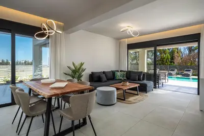 a living room with a table and a couch at Terra Magna Villas in Kiotari