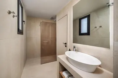 a bathroom with a white sink and a shower at Terra Magna Villas in Kiotari