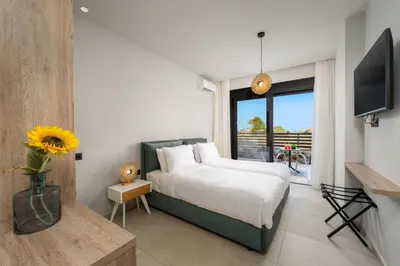 a bedroom with a bed and a large window at Terra Magna Villas in Kiotari