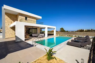 a villa with a swimming pool and a house at Terra Magna Villas in Kiotari