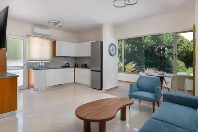 a kitchen and living room with a couch and a table at Celestial City Suite in Rhodes Town