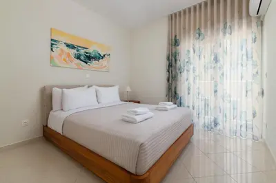 a bedroom with a bed with two towels on it at Celestial City Suite in Rhodes Town