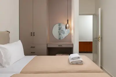 a bedroom with a bed with two towels on it at Celestial City Suite in Rhodes Town
