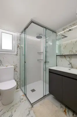 a bathroom with a shower and a toilet and a sink at Celestial City Suite in Rhodes Town