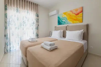 two beds sitting next to each other in a room at Celestial City Suite in Rhodes Town