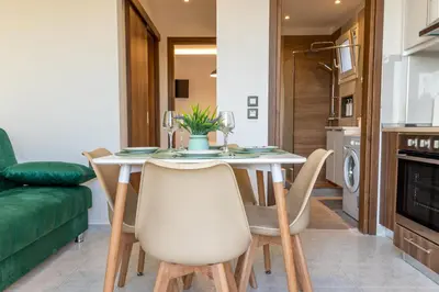 a kitchen and dining room with a table and chairs at Nikargy Avra in Koskinou