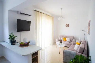 a living room with a couch and a tv at LiRa in Kremasti
