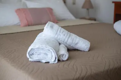 a rolled up towel on a bed at LiRa in Kremasti