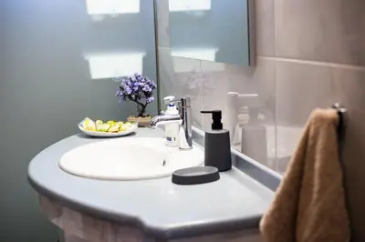 a bathroom sink with a bowl of fruit on it at LiRa in Kremasti
