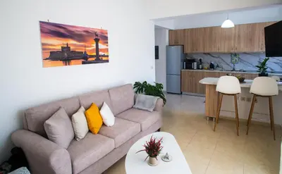 a living room with a couch and a kitchen at LiRa in Kremasti