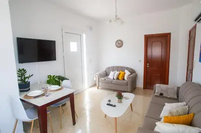 a living room with a couch and a table at LiRa 2 in Kremasti