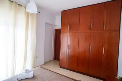 a bedroom with a large wooden cabinet in a room at LiRa 2 in Kremasti
