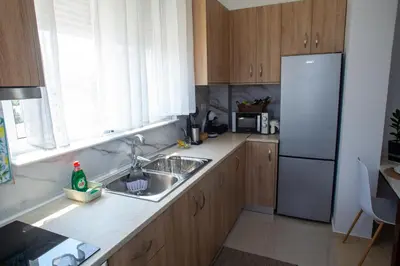 a kitchen with a sink and a refrigerator at LiRa 2 in Kremasti