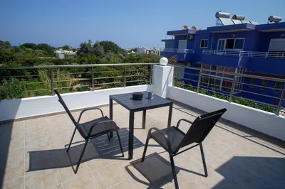 a patio with a table and chairs on a balcony at LiRa 2 in Kremasti