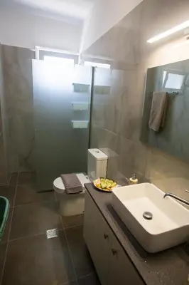 a bathroom with a sink and a toilet and a mirror at LiRa 2 in Kremasti