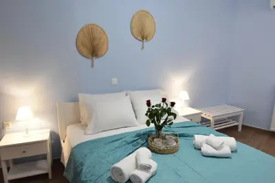 a bedroom with a bed with towels on it at Charavgi House in Archangelos