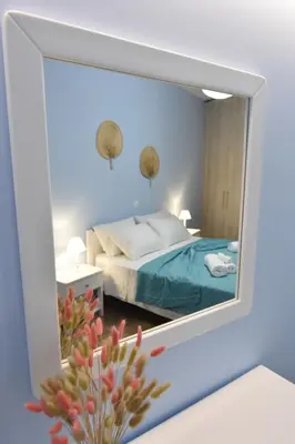 a mirror reflection of a bed in a bedroom at Charavgi House in Archangelos
