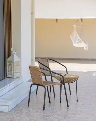 two chairs sitting next to each other in a building at Harmony House in Faliraki