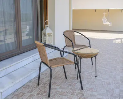 two chairs and a table on a patio at Harmony House in Faliraki