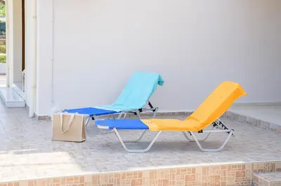 two chairs and a bag on a patio at Harmony House in Faliraki