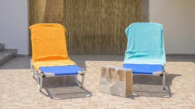 two beach chairs sitting next to each other at Harmony House in Faliraki