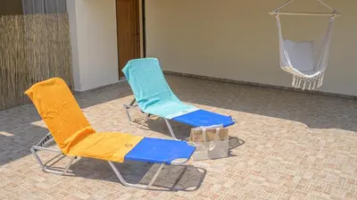 two chairs sitting next to a basketball hoop at Harmony House in Faliraki